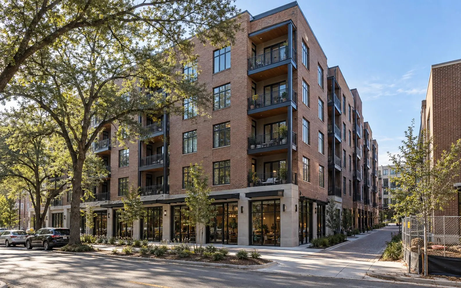 Five-story brick apartment building with shops at street level